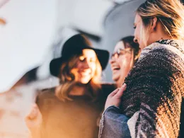 People laughing and connecting in warm golden light