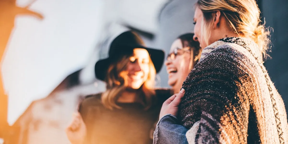 People laughing and connecting in warm golden light